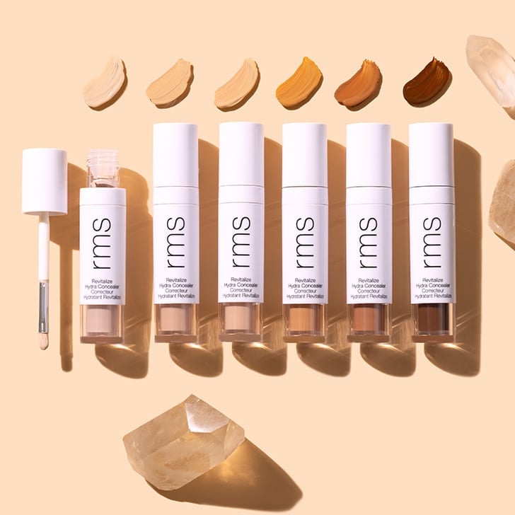 RMS Beauty ReVitalize Hydra Concealer Group Image on peach background with product swatches