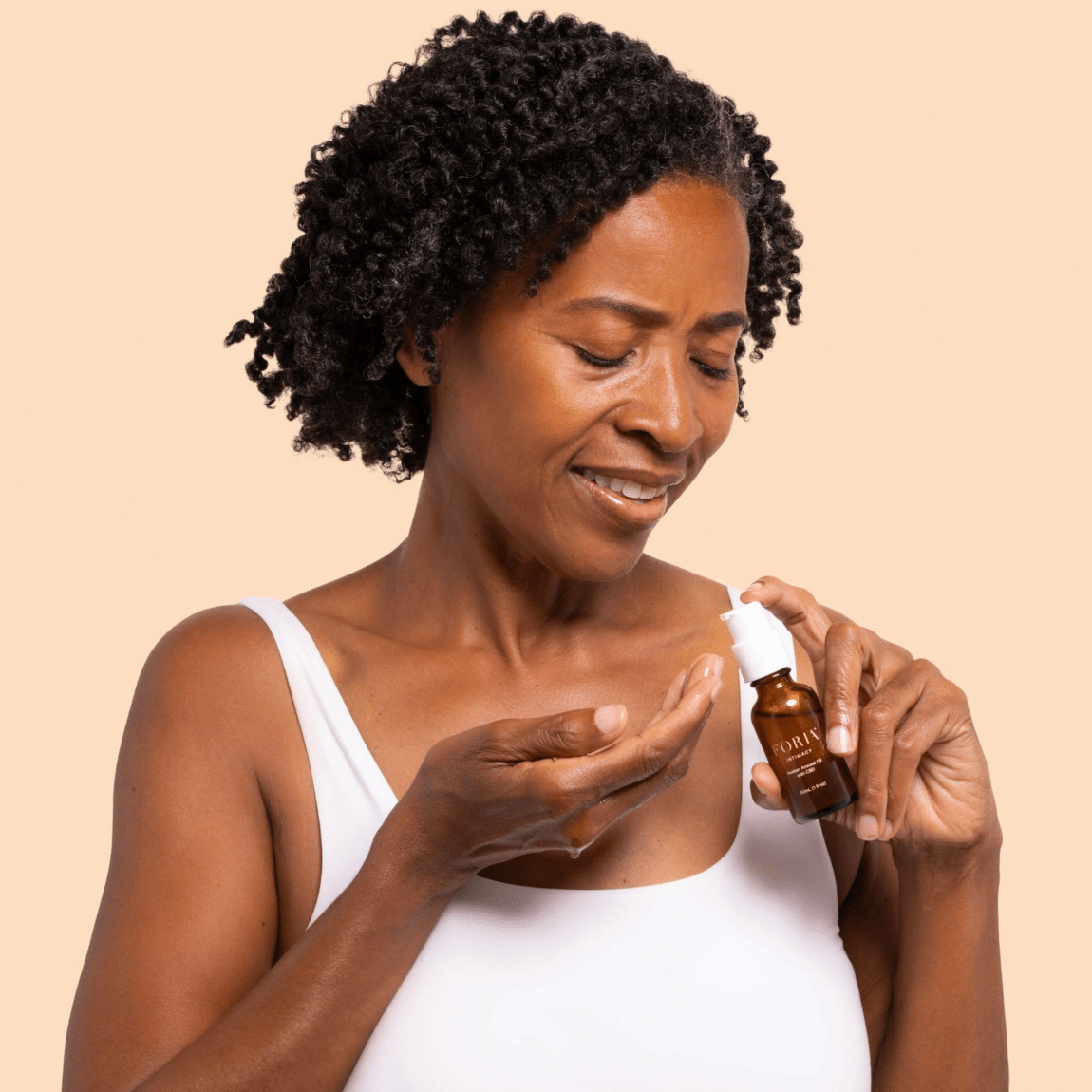 A woman with Foria Intimacy Oil With CBD