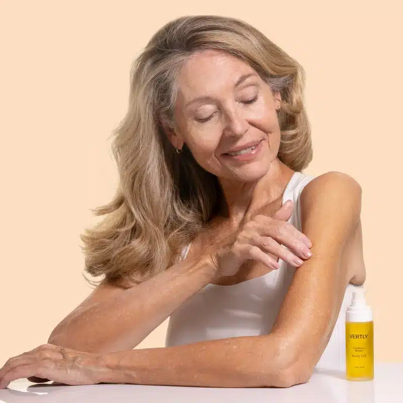 an image of vertly body oil being used